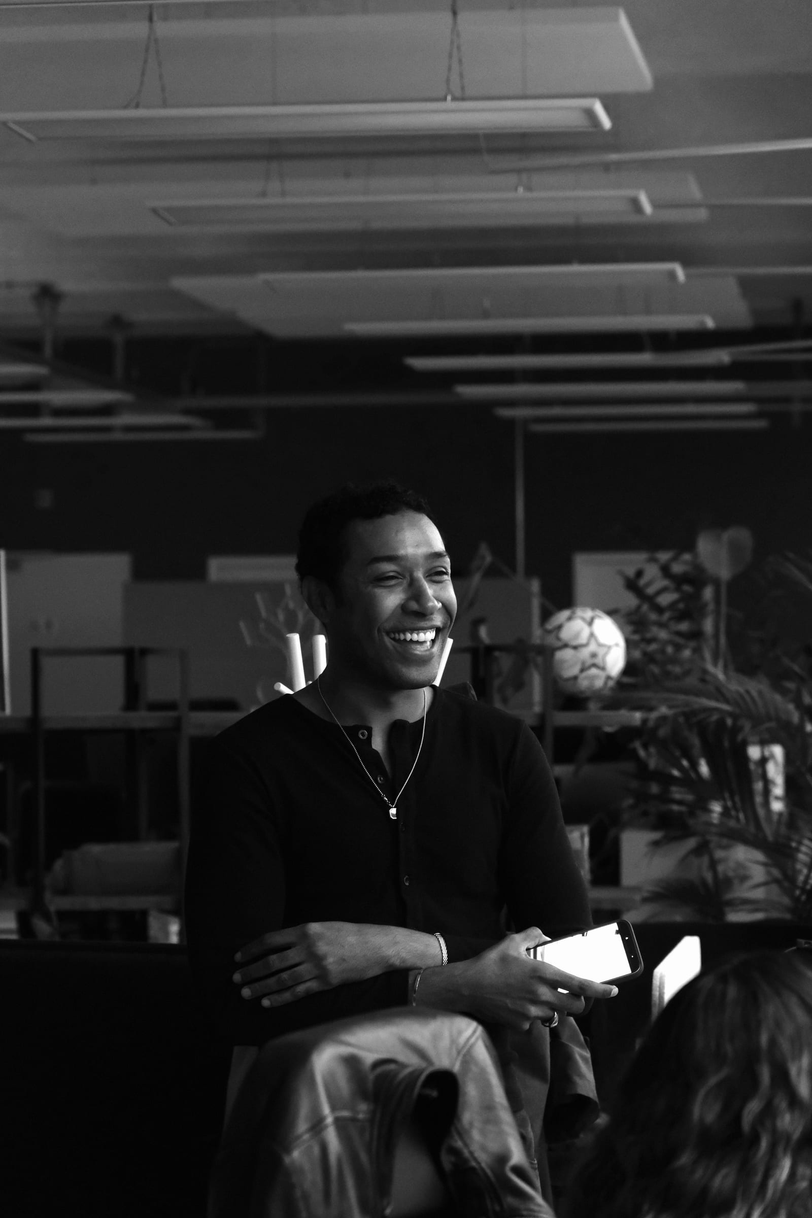 A hackathon attendee laughing during a conversation at Everphone