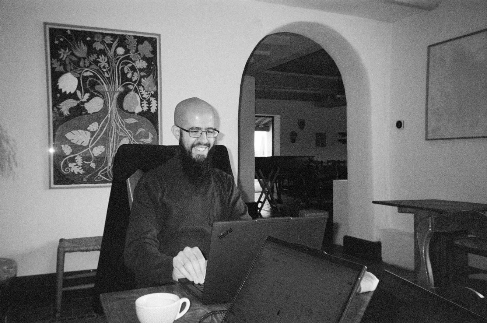 A Lighter smiling at a laptop, building during the hackathon