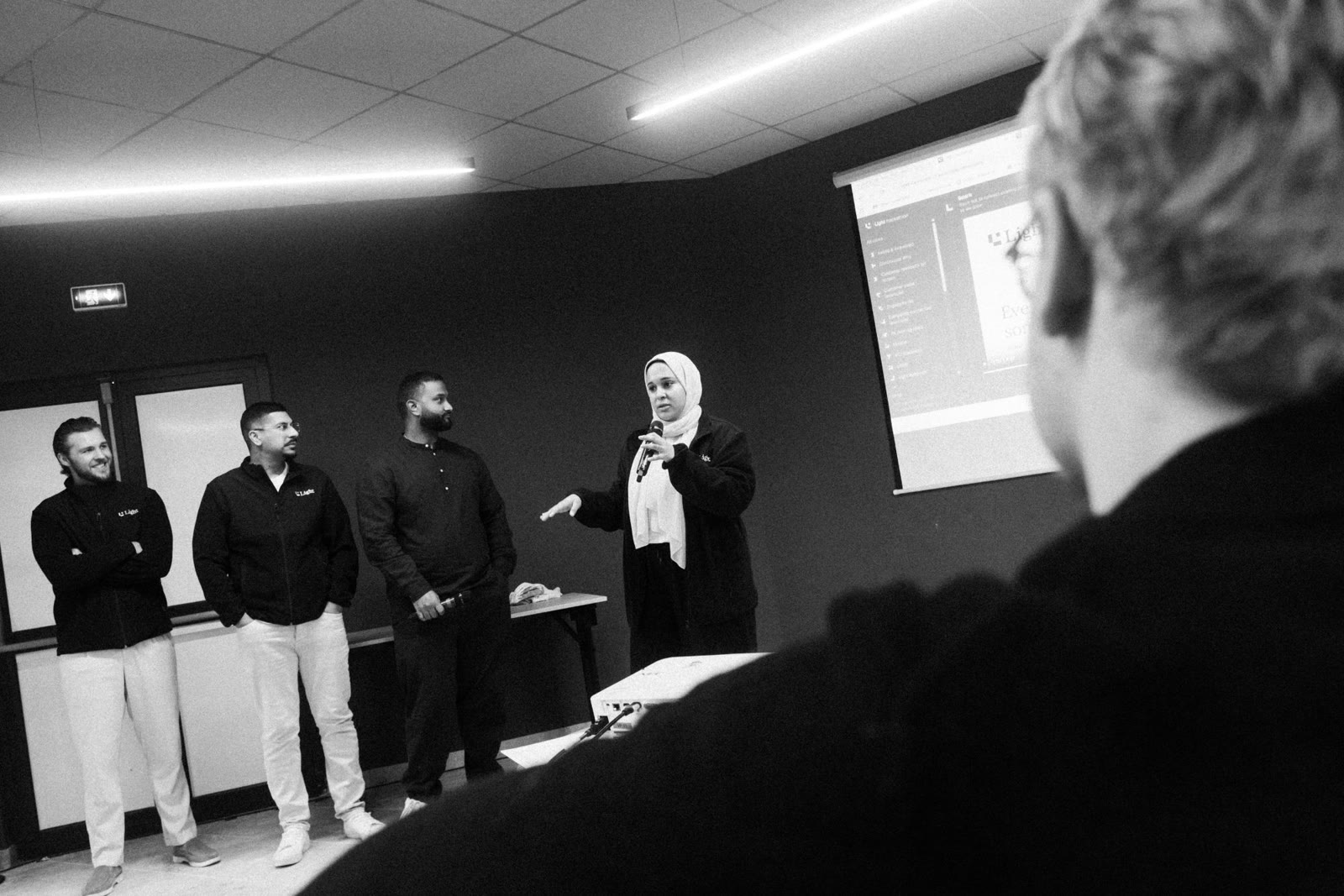 A hackathon team presenting their build to the room