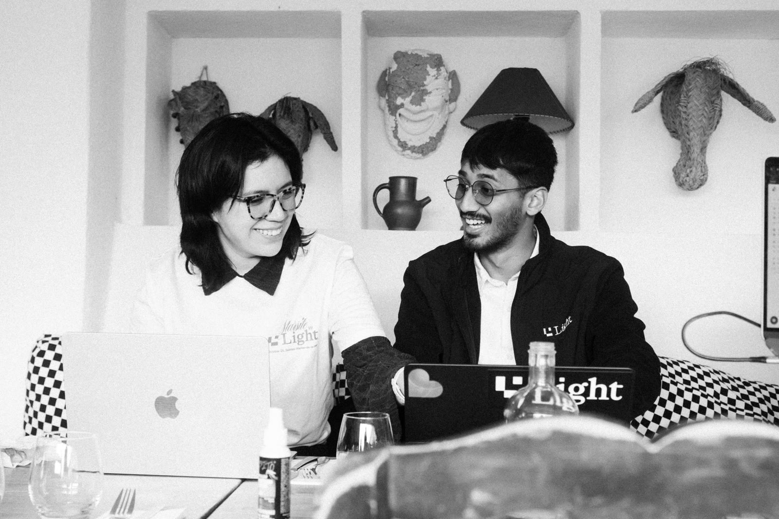 Two Lighters laughing over their laptops during the Starsite X hackathon