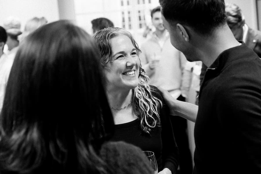 Teammates laughing together at a social gathering