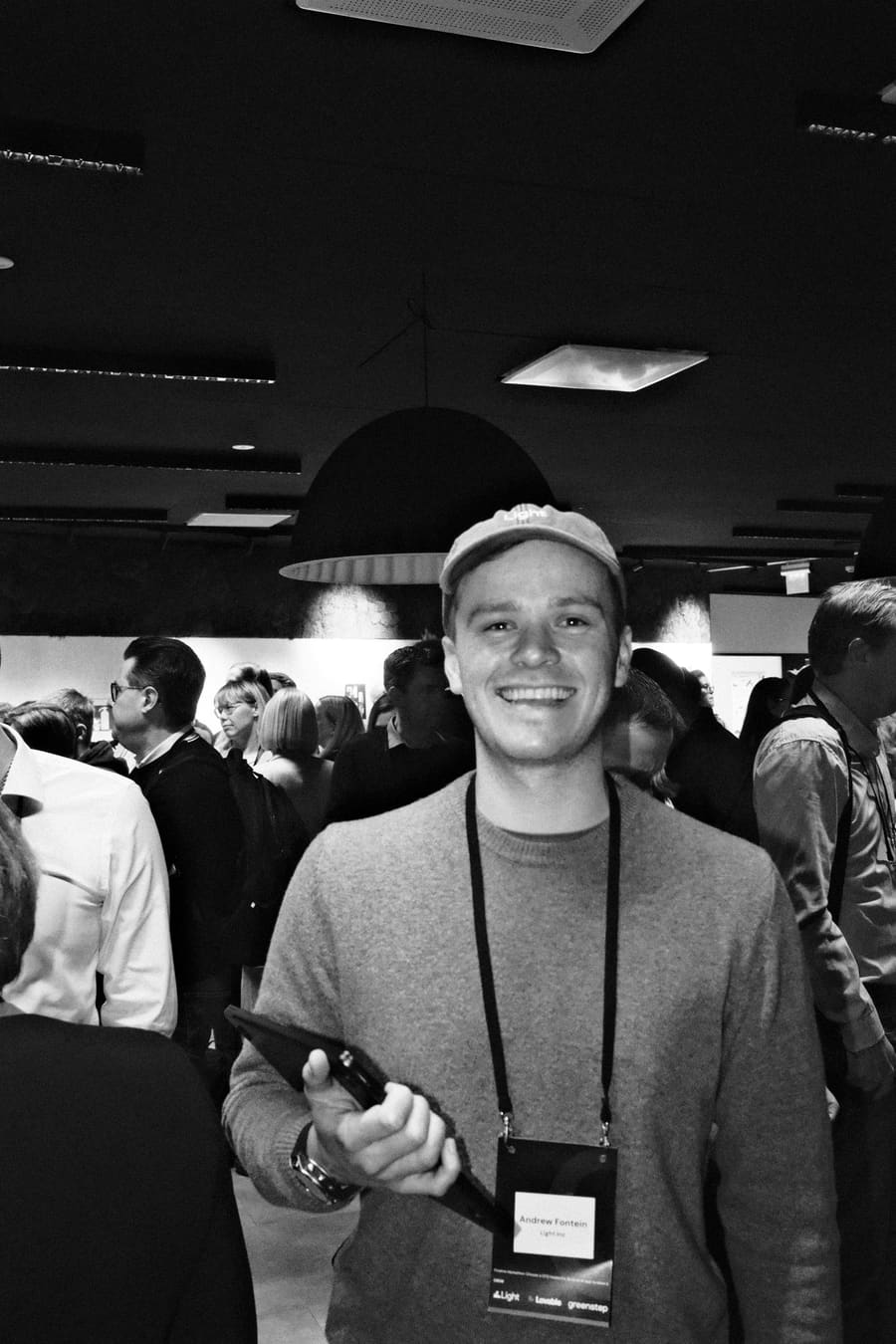 A teammate smiling and waving at an evening event