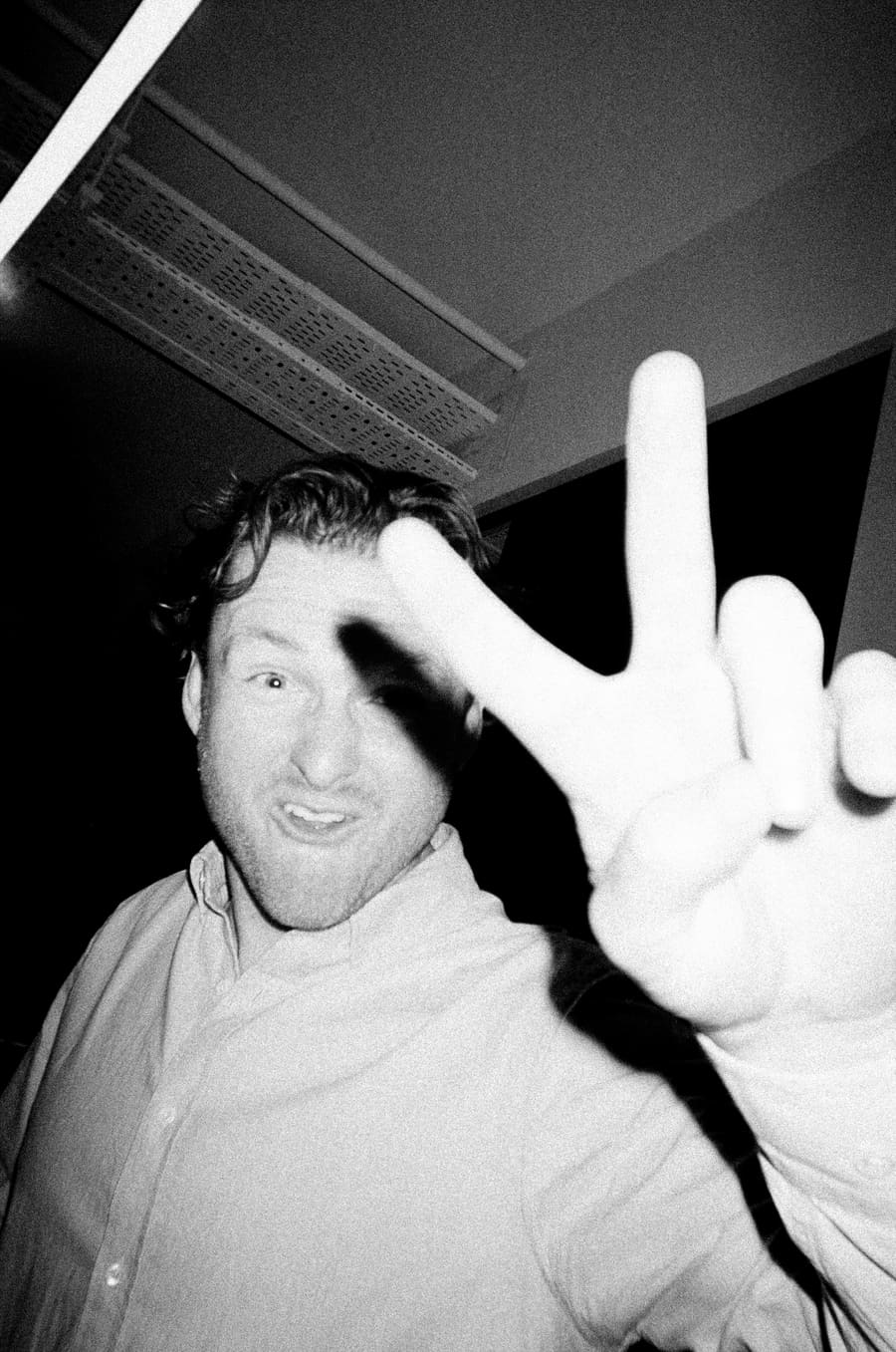 A teammate flashing a peace sign at a team night out