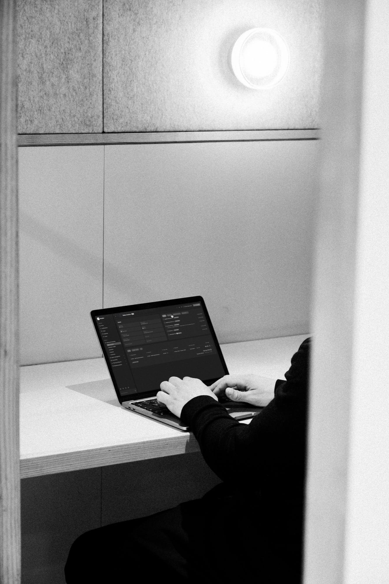Light open on a laptop in a quiet booth