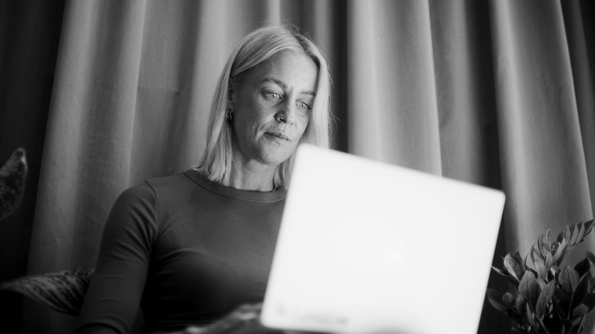 Harriet Stewart working through the books on a laptop